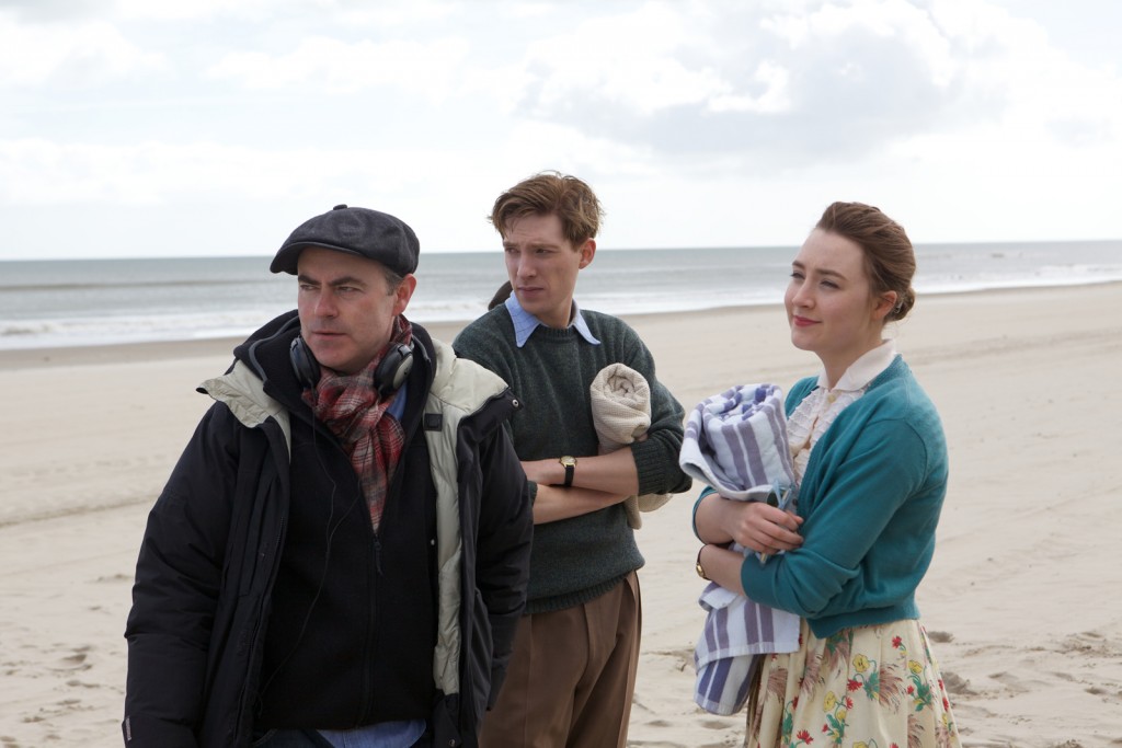 Director John Crowley, Domhnall Gleeson, and Saoirse Ronan on the set of BROOKLYN. Photo by Kerry Brown. © 2015 Twentieth Century Fox Film Corporation All Rights Reserved