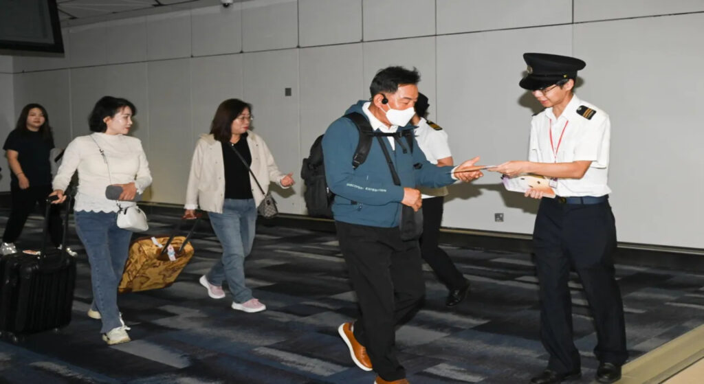 Staff of FEHD distributes promotional leaflets to incoming visitors at the Hong Kong International Airport on October 8, 2023